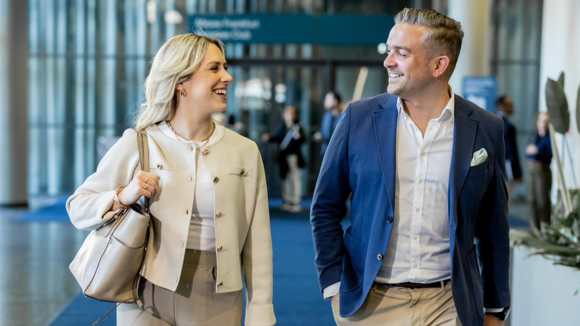 A woman and a man are chatting while walking