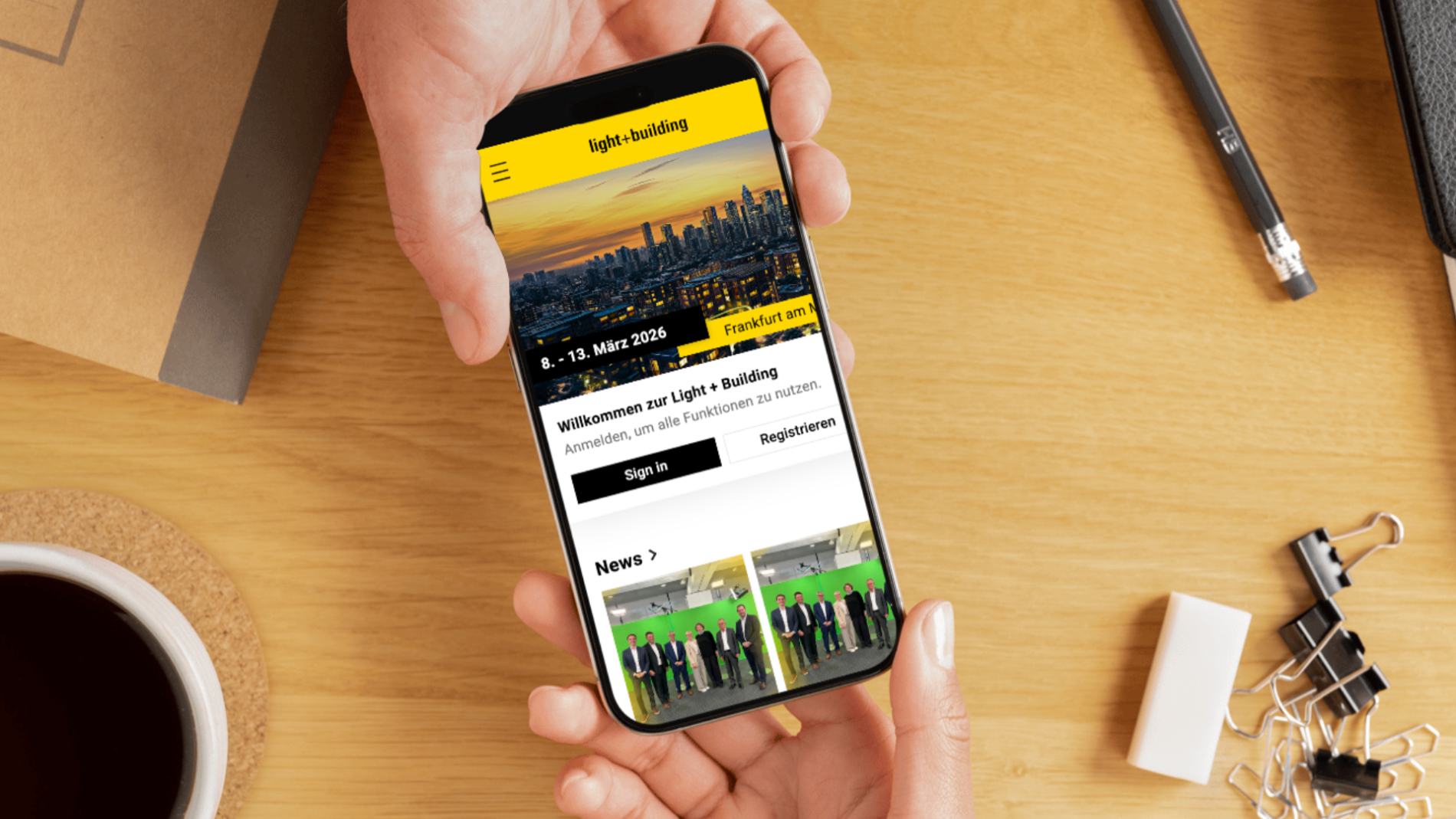 A smartphone displays the Light + Building Navigator app